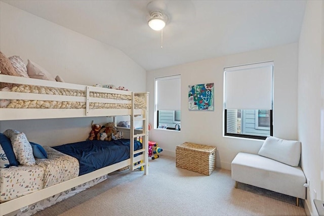 carpeted bedroom with vaulted ceiling and ceiling fan