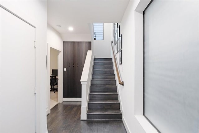 staircase with wood-type flooring