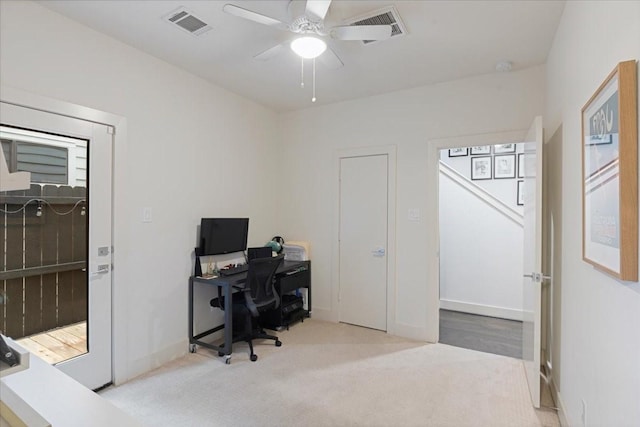 office space featuring ceiling fan and light colored carpet