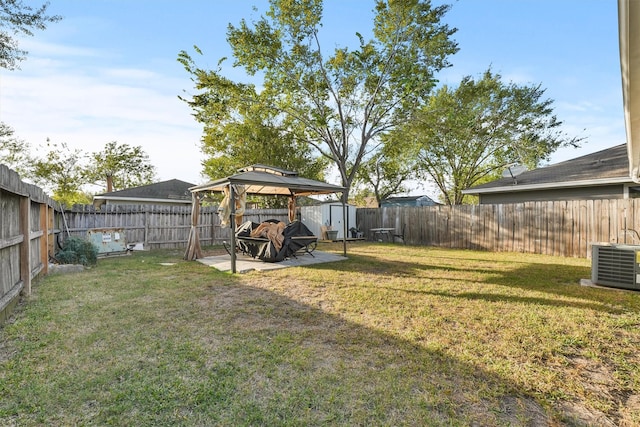 view of yard featuring a gazebo, central AC unit, and a storage unit