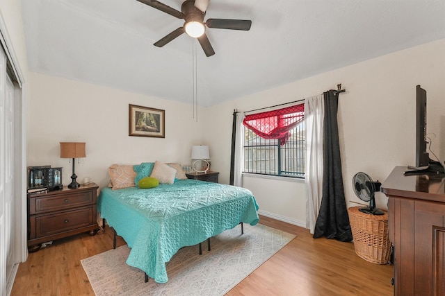 bedroom with light wood-type flooring and ceiling fan