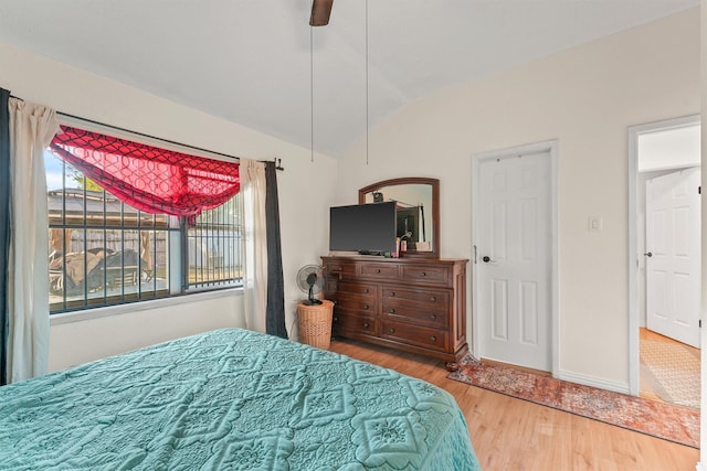 bedroom with hardwood / wood-style flooring, ceiling fan, and lofted ceiling