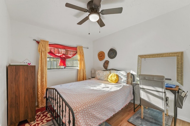 bedroom with ceiling fan and hardwood / wood-style floors