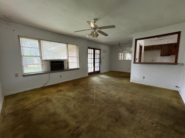 unfurnished living room with carpet flooring, plenty of natural light, cooling unit, and ceiling fan with notable chandelier