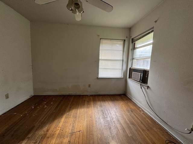 unfurnished room featuring hardwood / wood-style floors, ceiling fan, and cooling unit