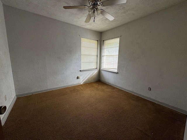 spare room with carpet, ceiling fan, and a textured ceiling