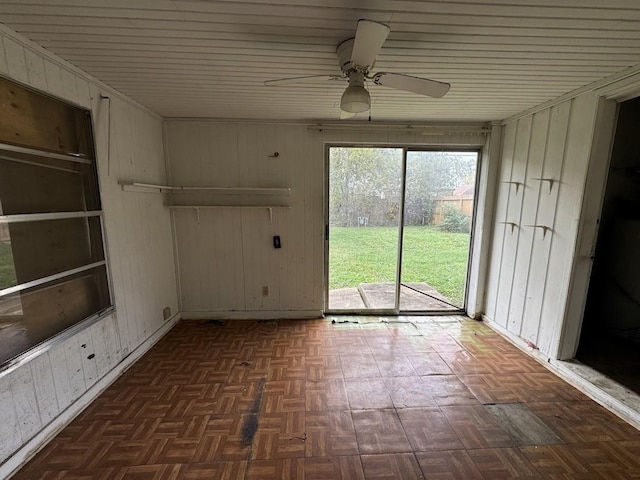 unfurnished sunroom featuring ceiling fan and wood ceiling