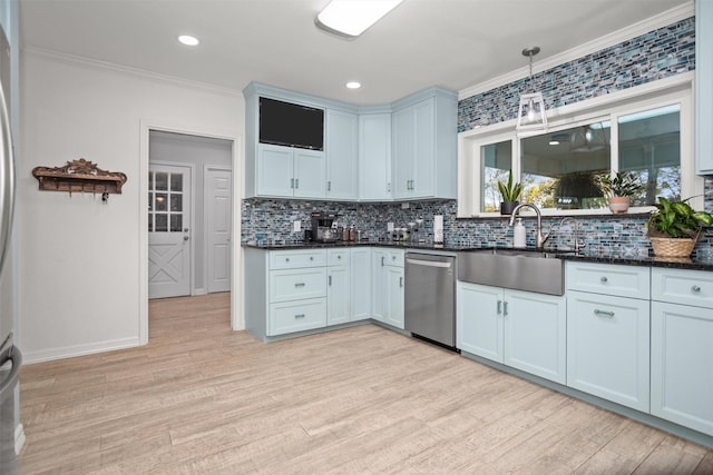 kitchen with stainless steel dishwasher, pendant lighting, light wood-type flooring, and ornamental molding