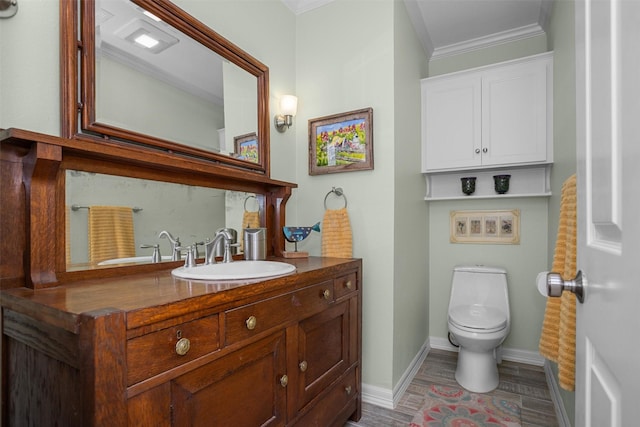 bathroom featuring vanity, toilet, wood-type flooring, and ornamental molding