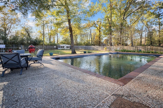 view of swimming pool featuring a yard and a patio