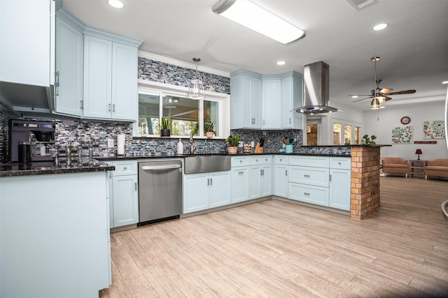 kitchen with dishwasher, sink, light hardwood / wood-style flooring, wall chimney exhaust hood, and ornamental molding