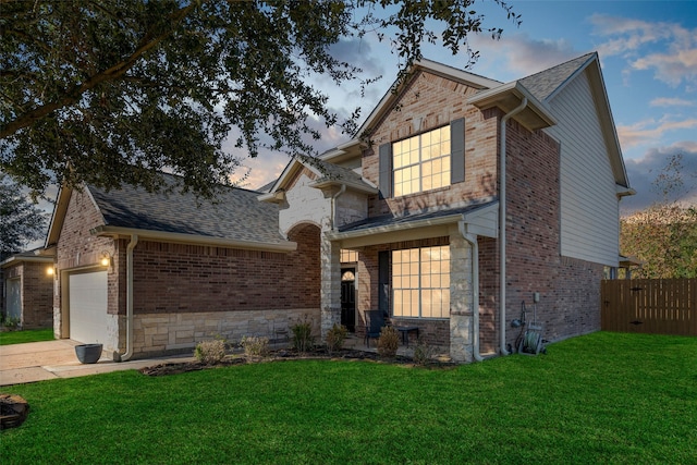 view of front of house featuring a lawn and a garage