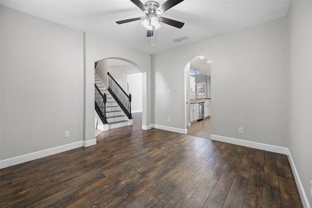 unfurnished living room with dark wood-type flooring and ceiling fan