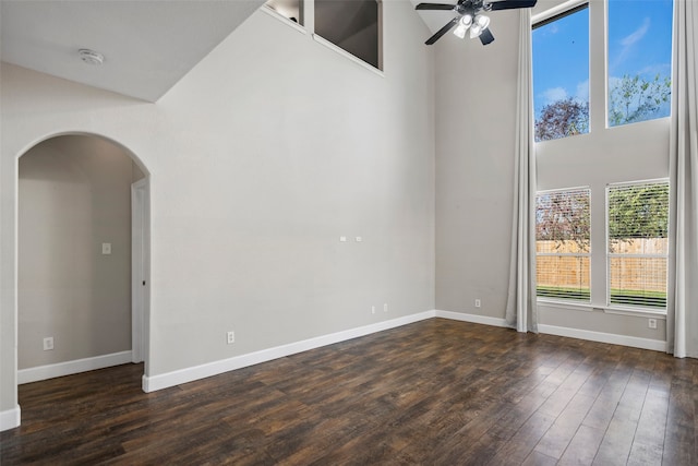 spare room with dark hardwood / wood-style floors and ceiling fan