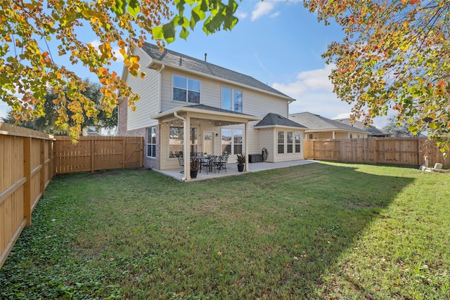 back of property with a patio area and a lawn