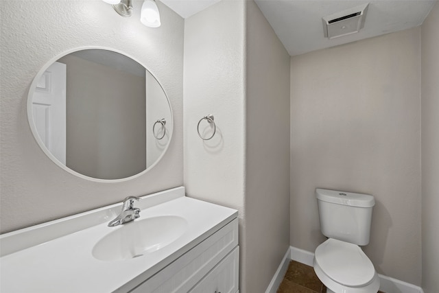 bathroom with vanity, tile patterned floors, and toilet