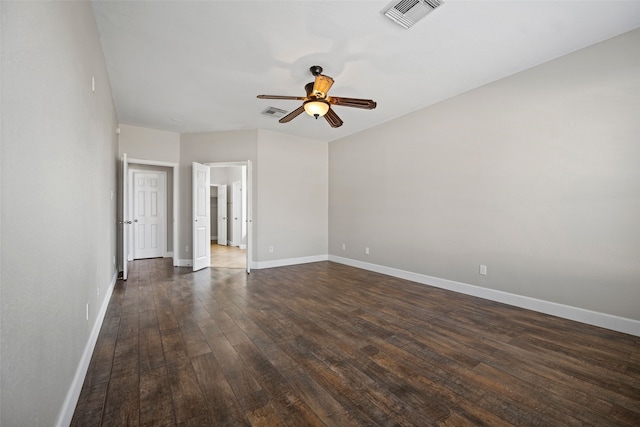 spare room with dark wood-type flooring and ceiling fan