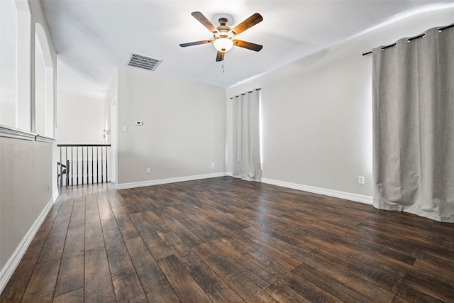 spare room with dark wood-type flooring and ceiling fan