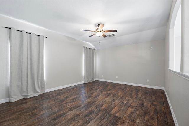 spare room with lofted ceiling, dark wood-type flooring, and ceiling fan