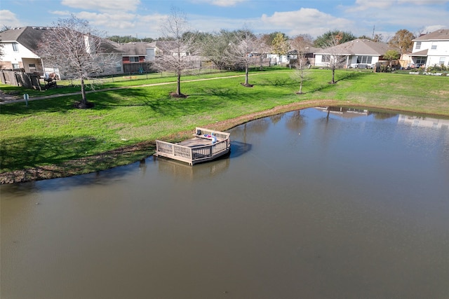 dock area featuring a water view and a lawn