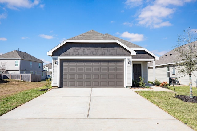 view of front facade featuring a front yard, a garage, and central air condition unit