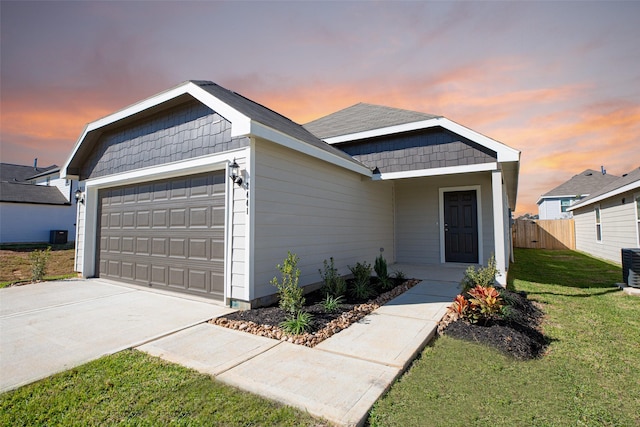 ranch-style house featuring a lawn and a garage