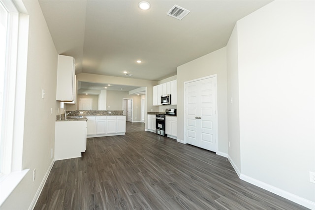 kitchen with white cabinets, stainless steel appliances, dark hardwood / wood-style floors, and sink