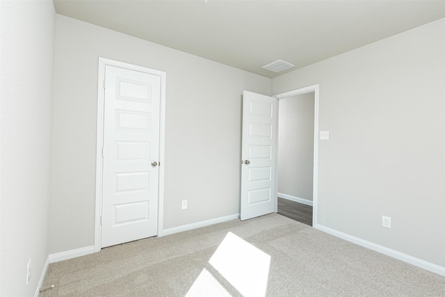 unfurnished bedroom with light carpet