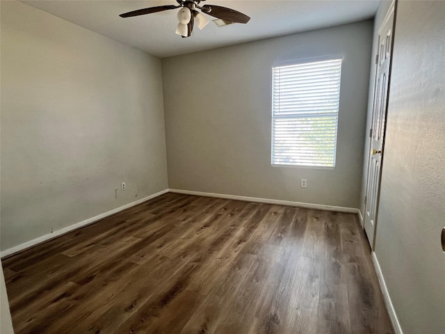 spare room featuring dark hardwood / wood-style floors and ceiling fan