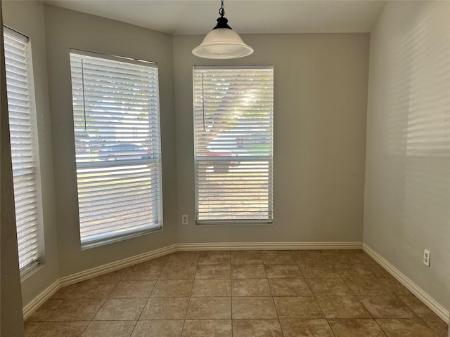 unfurnished dining area featuring tile patterned flooring