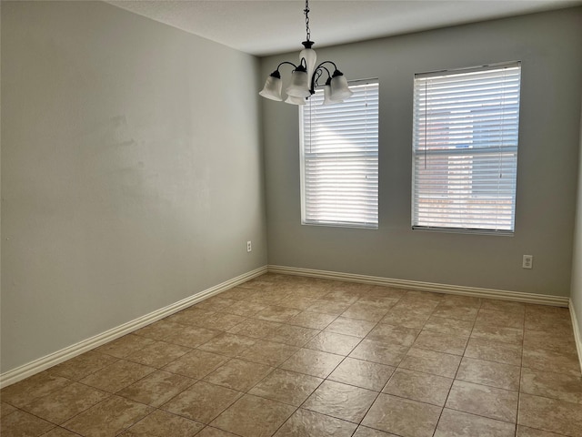 unfurnished room featuring a chandelier, light tile patterned floors, and a wealth of natural light