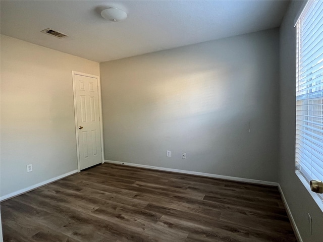 unfurnished room featuring dark hardwood / wood-style flooring