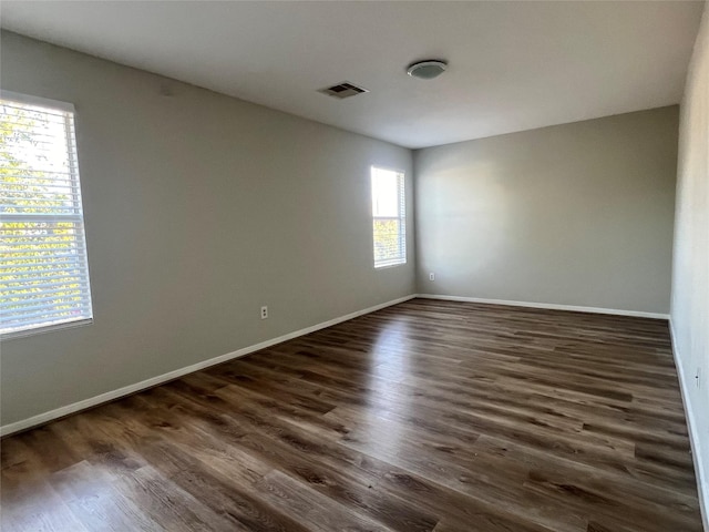 unfurnished room featuring dark hardwood / wood-style floors