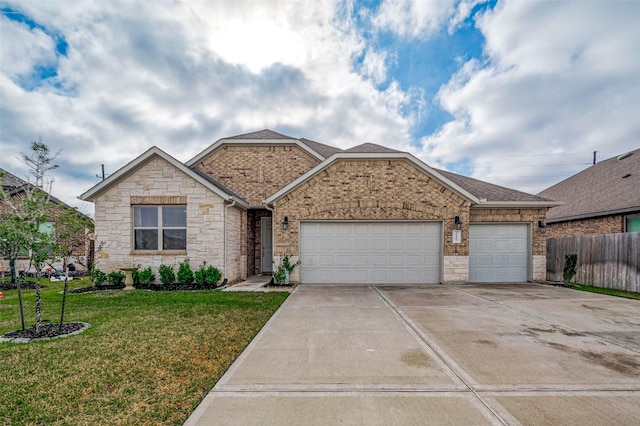 view of front of property with a garage and a front yard