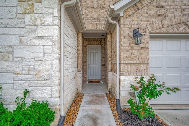 doorway to property with a garage