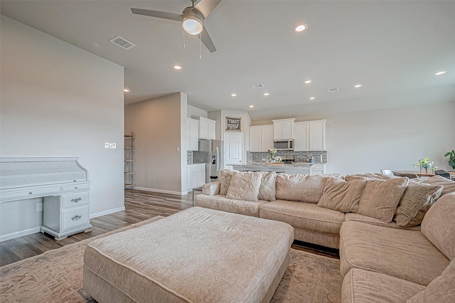 living room featuring ceiling fan and light hardwood / wood-style flooring