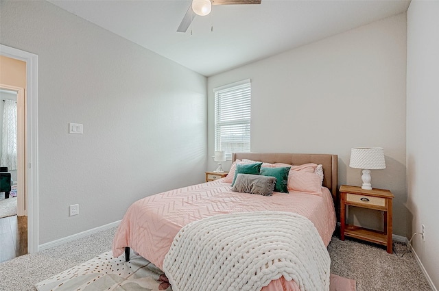 carpeted bedroom featuring ceiling fan and vaulted ceiling