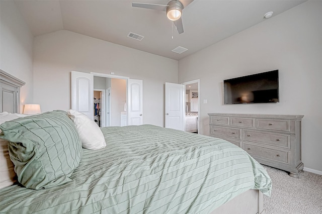 bedroom featuring lofted ceiling, ceiling fan, a spacious closet, light colored carpet, and a closet