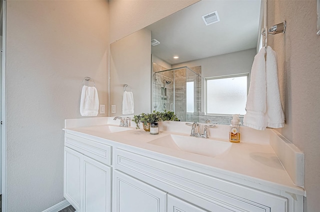 bathroom featuring vanity and an enclosed shower