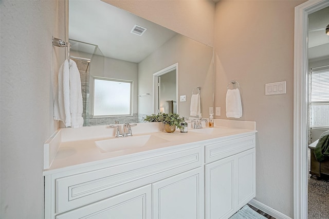 bathroom featuring vanity and a shower