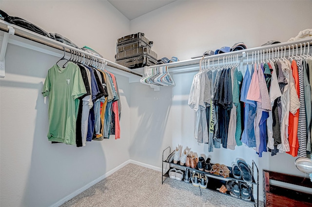 walk in closet with carpet