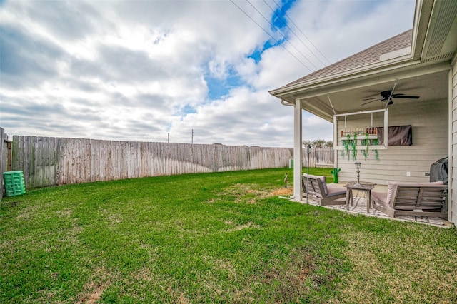 view of yard featuring ceiling fan and a patio area