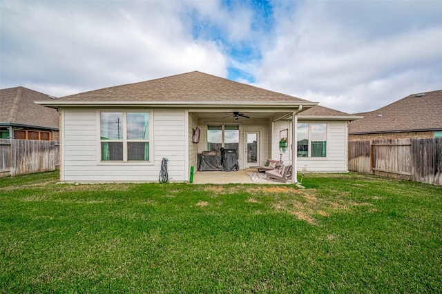 back of property featuring ceiling fan, a patio area, and a lawn