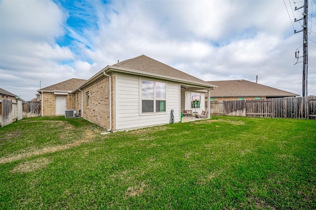 back of house with a yard, a patio area, and central air condition unit