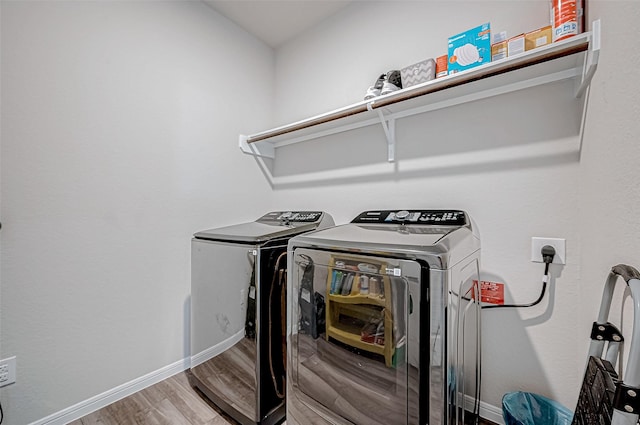 laundry area featuring separate washer and dryer and wood-type flooring