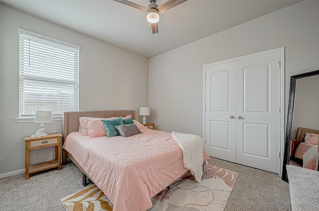 carpeted bedroom with a closet and ceiling fan