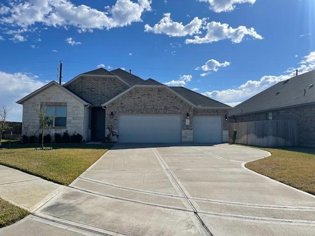 ranch-style home with a garage and a front lawn