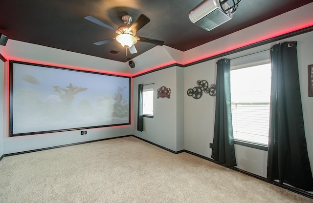 carpeted home theater with ceiling fan