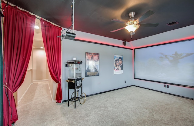 carpeted cinema room with ceiling fan