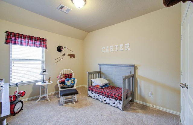 carpeted bedroom featuring vaulted ceiling